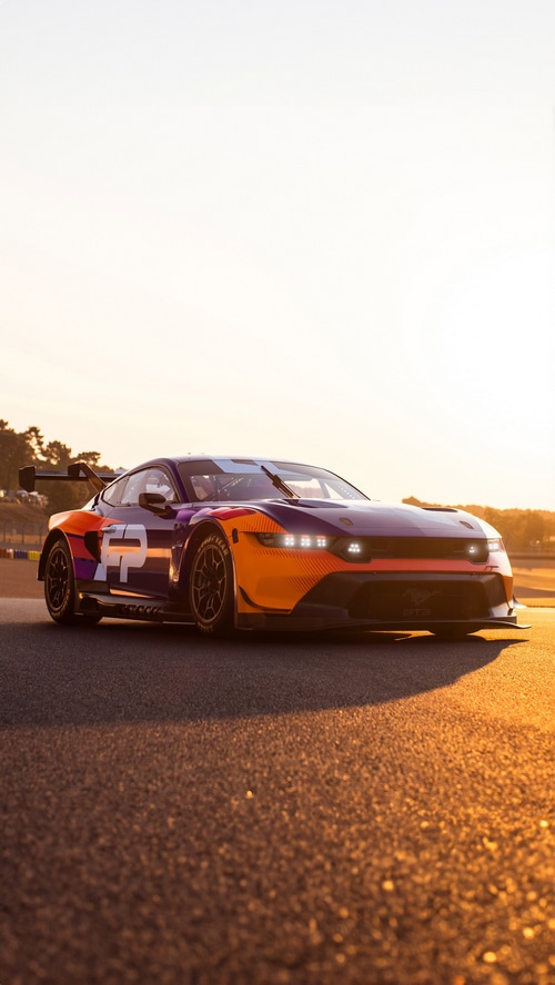 Ford Mustang GT3 race car on a track at sunset