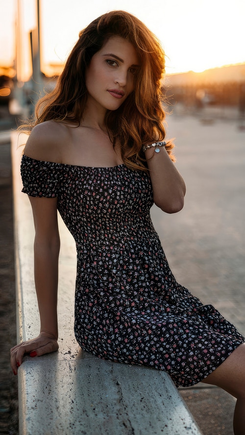 Woman in a floral dress at sunset