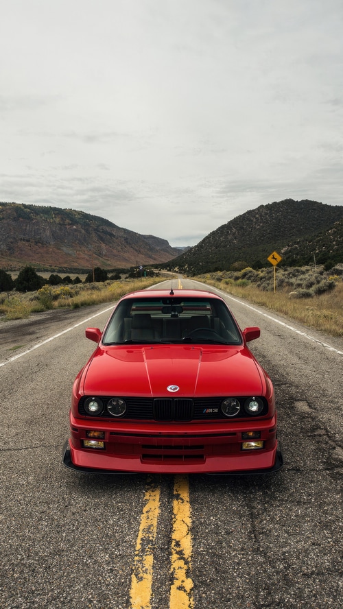 Red BMW E30 M3 on a Mountain Road