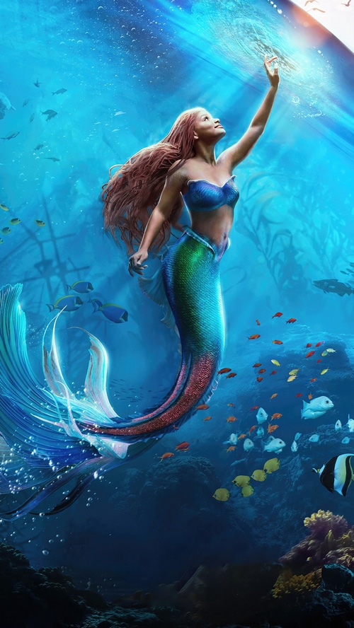 Ariel the mermaid reaching for light in the ocean