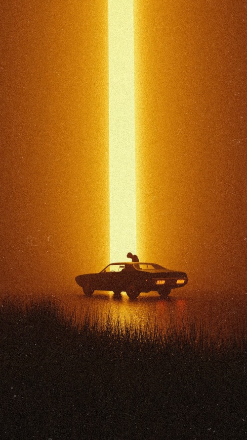 Silhouette of a person on a car under a light beam