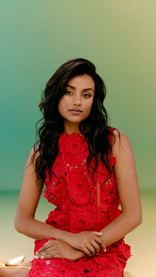 Simone Ashley in a red floral dress