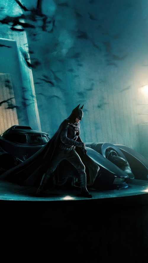 Batman and the Batmobile in a dark setting