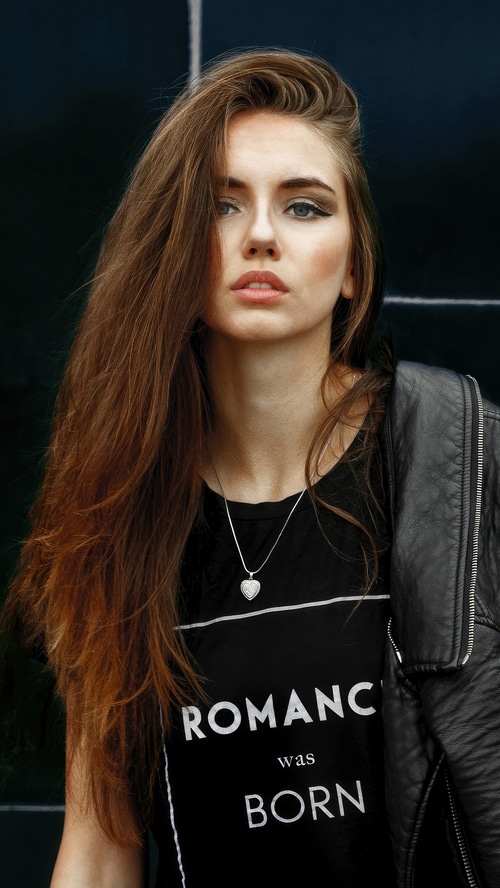 Model wearing a black t-shirt with text