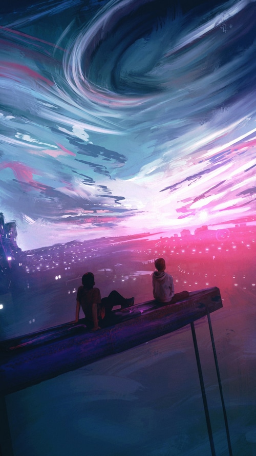 Two people watching a colorful sky over a city