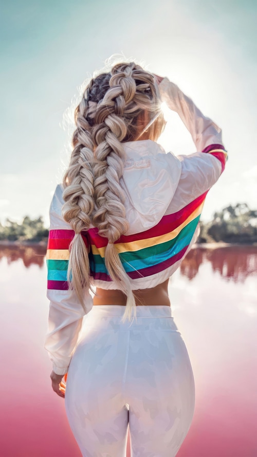 Woman with braided hair in a colorful jacket