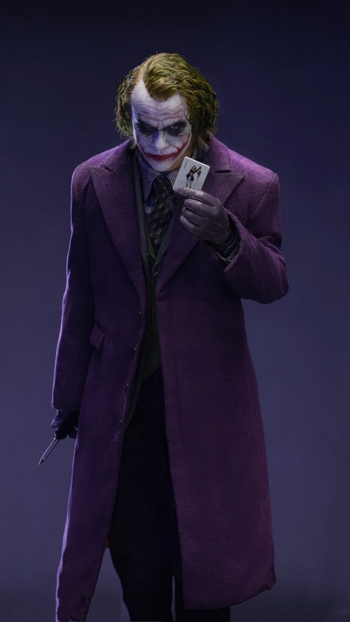 The Joker holding a playing card