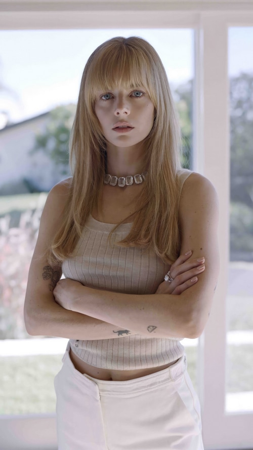 Model with blonde hair and bangs wearing a tank top