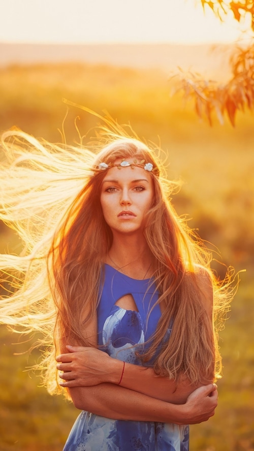 Woman with flower crown in golden hour light