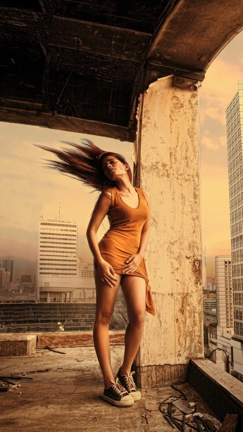 Woman in orange dress on a rooftop