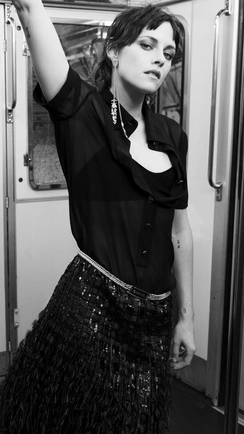 Kristen Stewart in a black outfit on a subway
