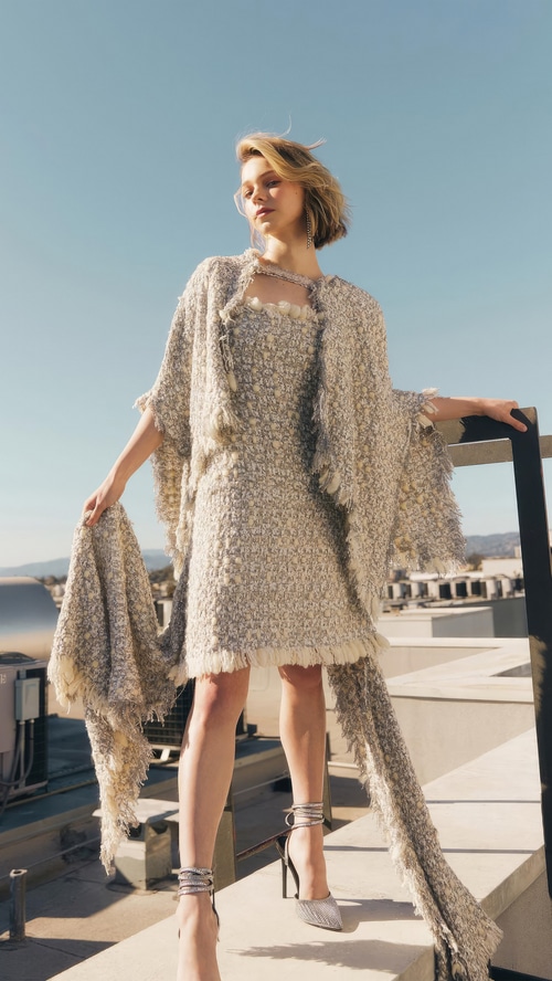 Emma Myers in a textured dress and cape