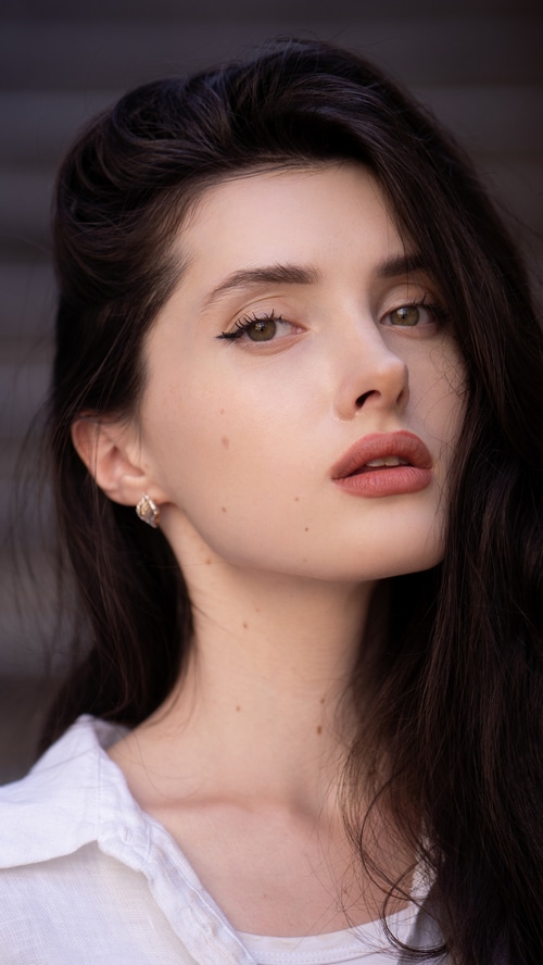 Young woman with dark hair and makeup