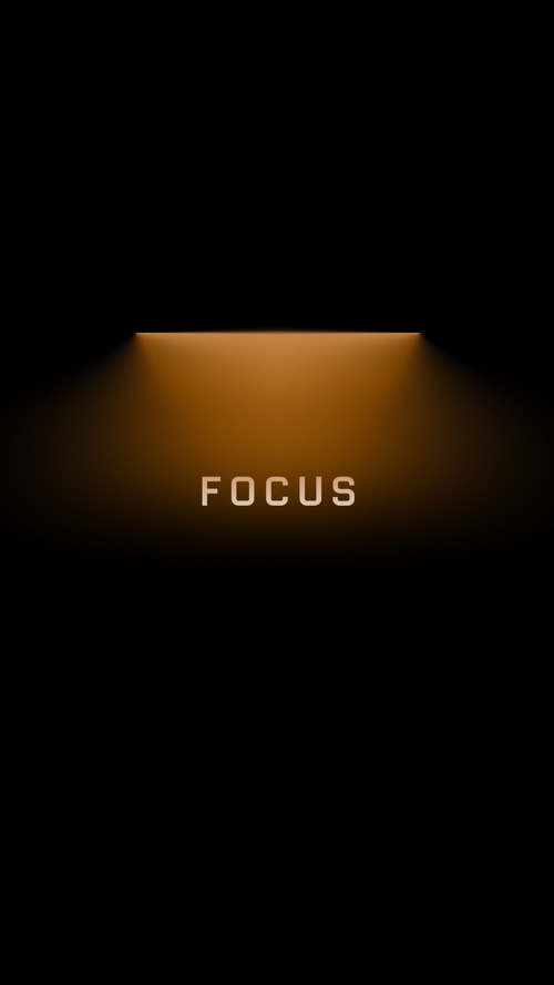 FOCUS typography on dark background with orange light