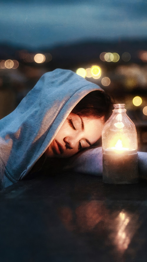 Delaia Gonzalez sleeping by candlelight