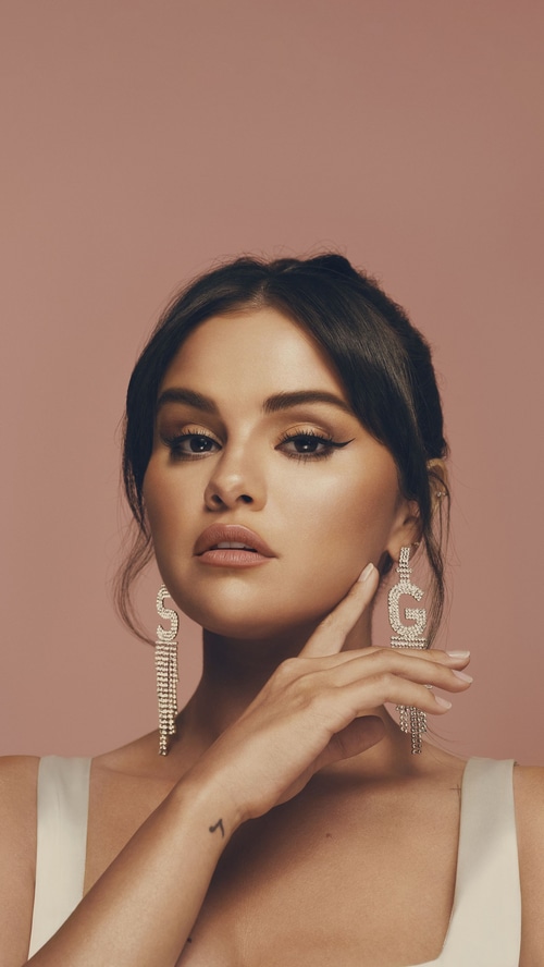 Selena Gomez wearing large sparkly earrings