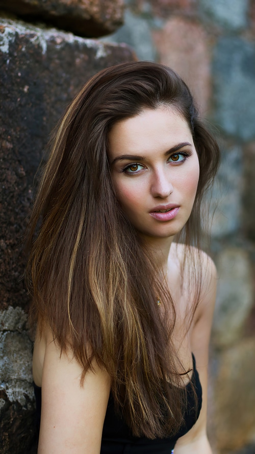 Model posing against a stone wall