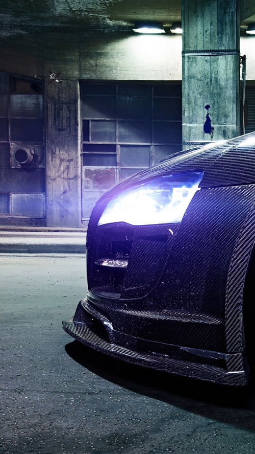 Audi R8 carbon fiber sports car with headlights on