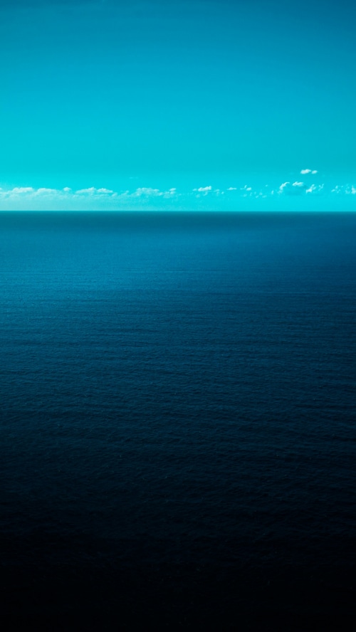 Vast ocean under a bright blue sky