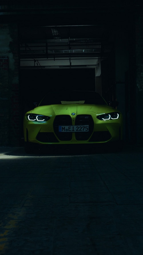BMW M4 parked in a dark garage