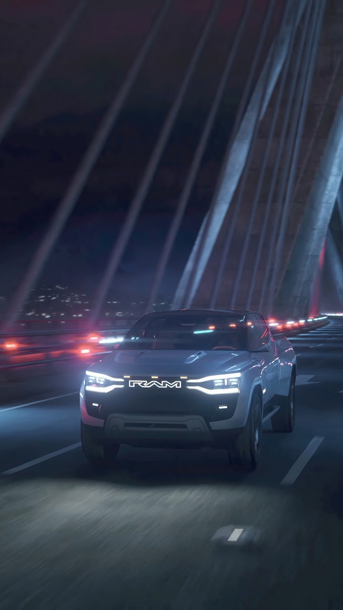 Ram electric concept truck driving on a bridge at night