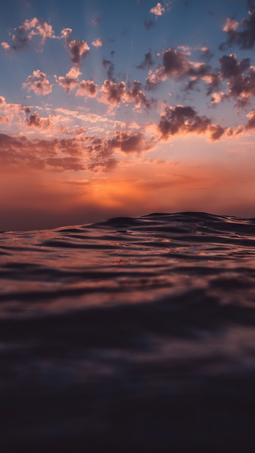 Sunset over the sea with clouds