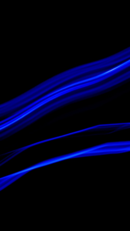 Abstract blue light streaks on black background