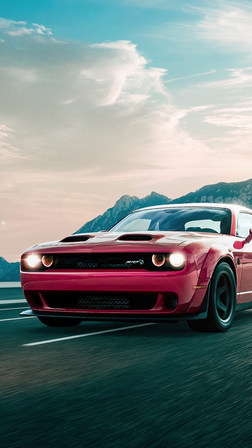 Red Dodge Challenger SRT driving on a road