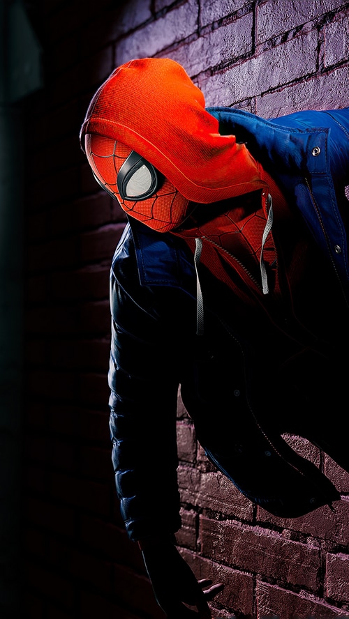 Spider-Man Miles Morales leaning on a brick wall