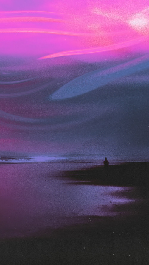 Person on beach at sunset with pink and purple sky