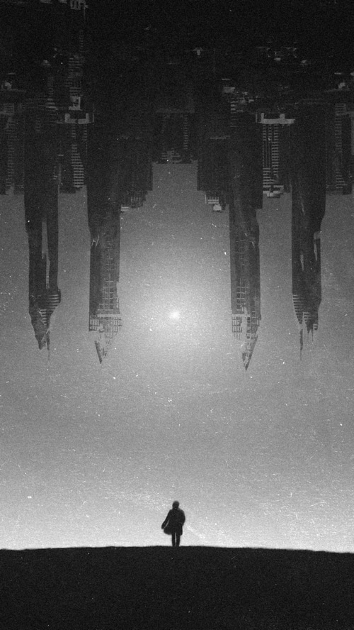 Monochrome Artwork of a Solitary Figure and Cityscape