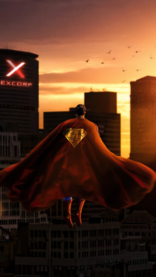 Superman flying over a city at sunset