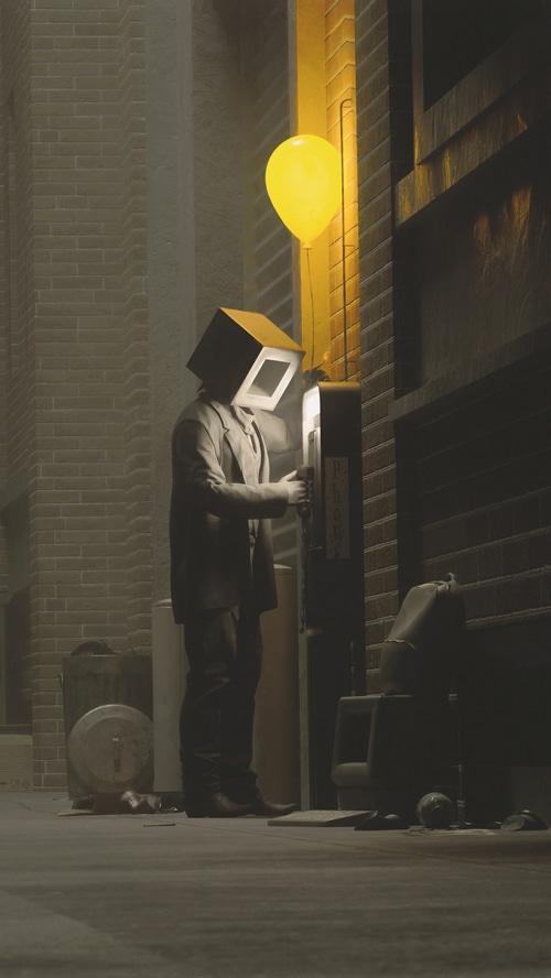Man with box head and balloon at payphone