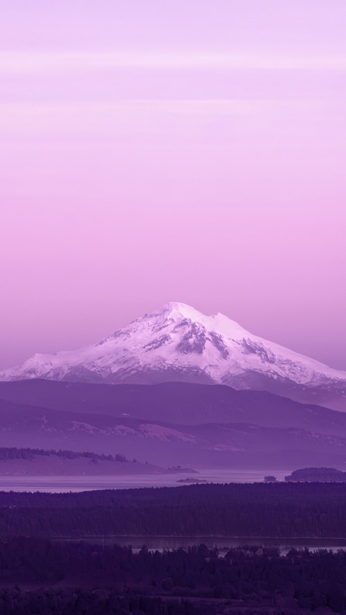Mount Baker covered in snow under a purple sky