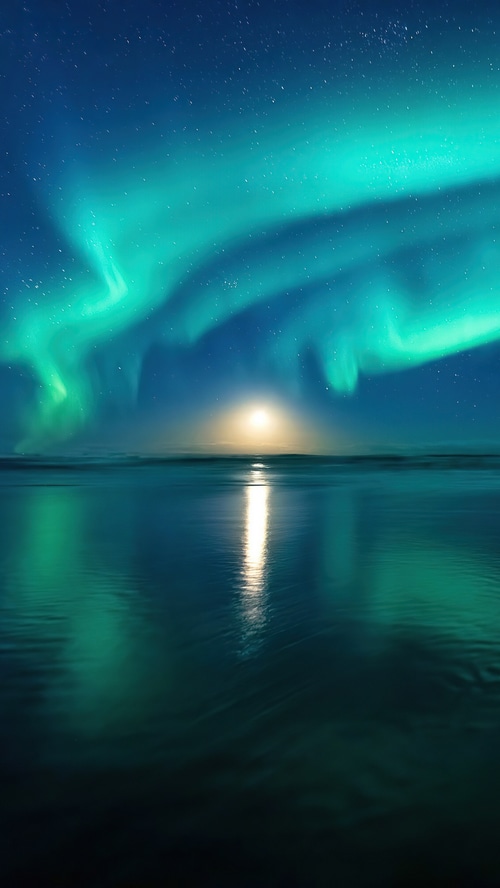 Aurora Borealis over ocean at night