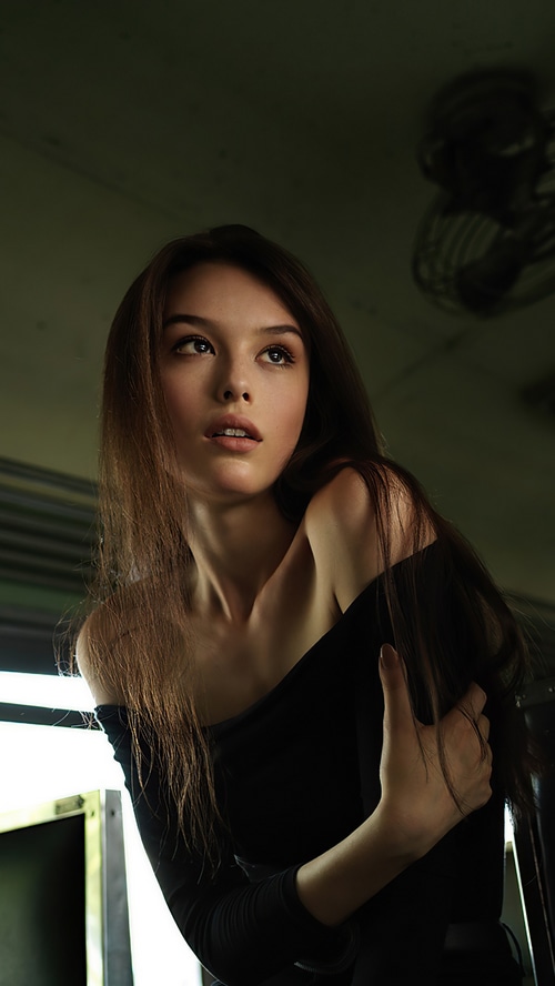Model in a black off-the-shoulder top