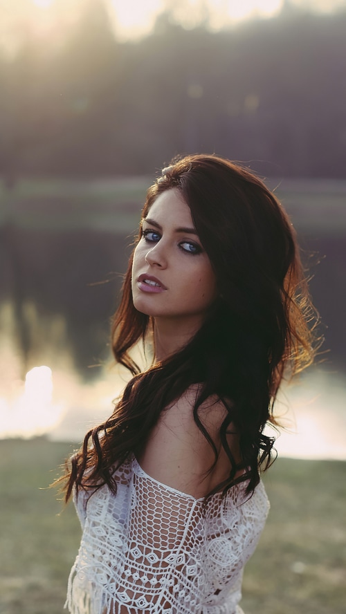 Aurela Skandaj in a white lace top