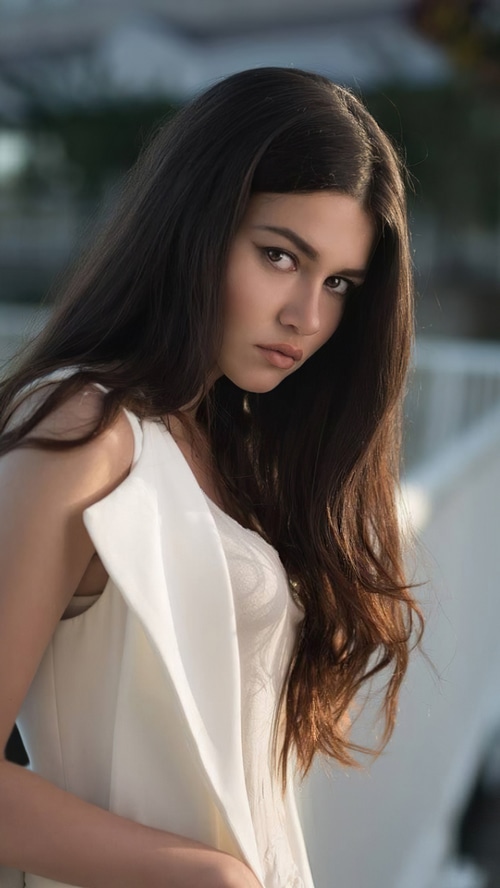 Model in white dress with long dark hair