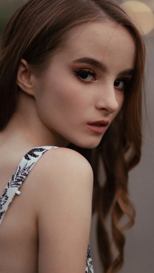 Young woman with brown hair and makeup