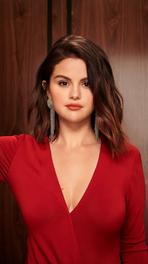Selena Gomez in a red dress with long earrings