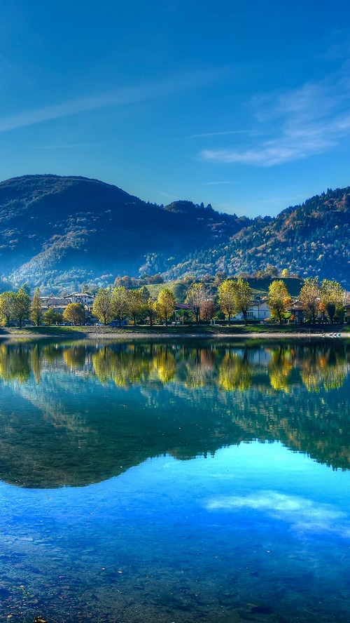 Lake with mountains and trees in Italy