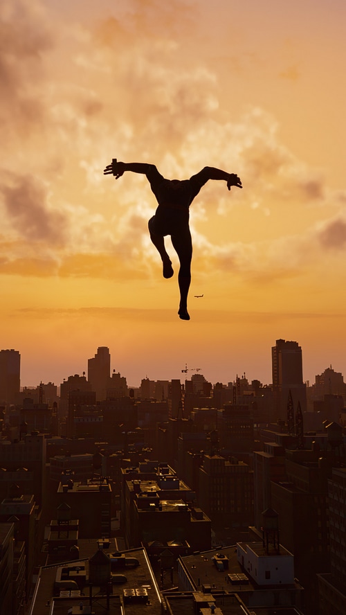 Spider-Man silhouette leaping over city at sunset