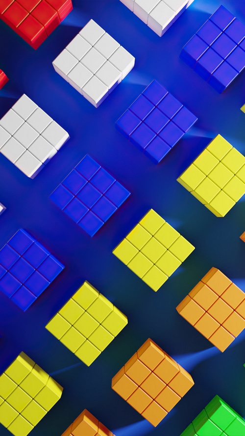 Abstract arrangement of colorful cubes on a blue surface