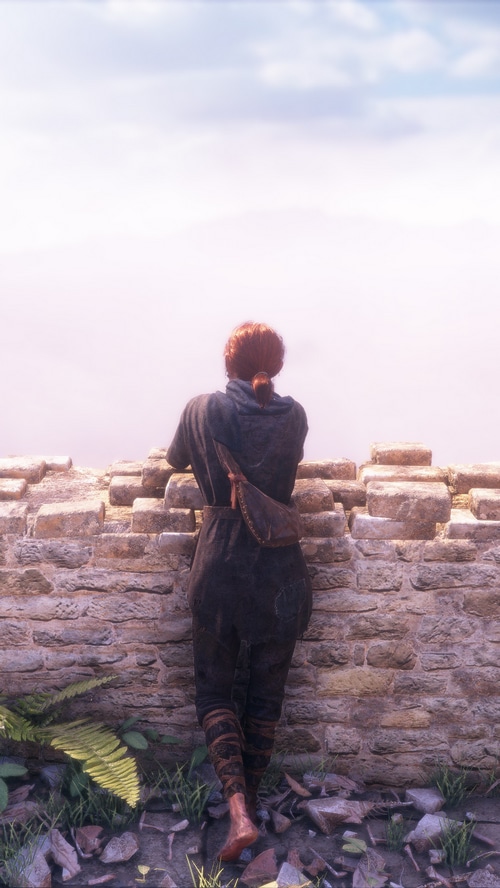A Plague Tale Innocence character looking over a wall