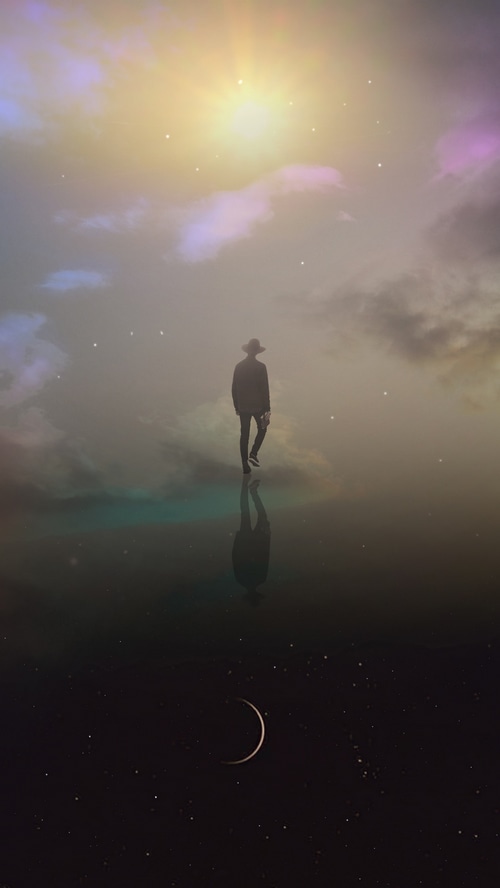 A lone figure walks across a reflective surface under a bright sky.