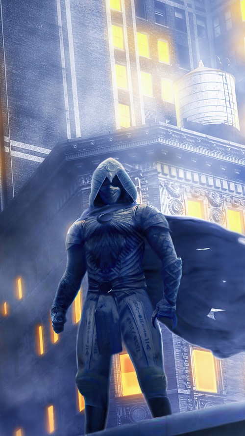 Moon Knight standing on a rooftop in a city at night