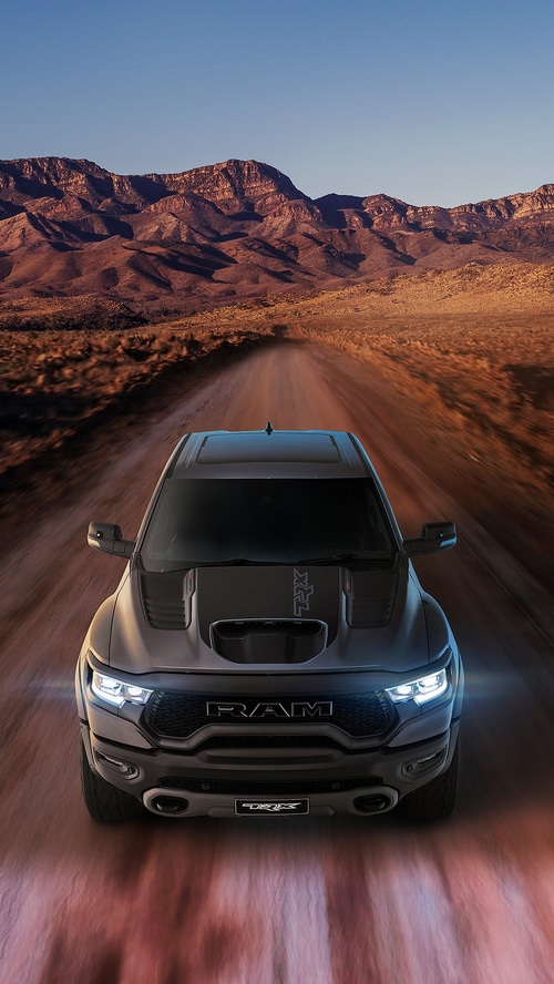 Ram TRX truck driving on a dirt road in the desert
