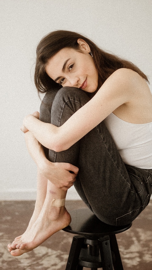Young woman sitting on a stool