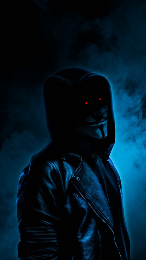 Anonymous figure in a black hoodie and leather jacket