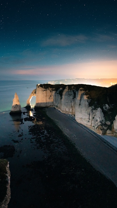 Etretat cliffs at night under a starry sky